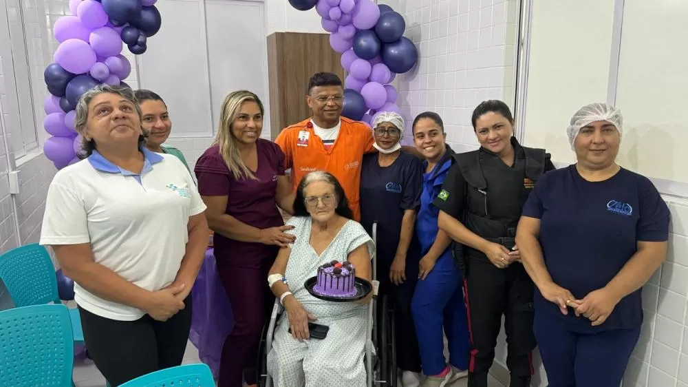 A paciente aniversariante e a equipe do hospital que organizou a comemoração